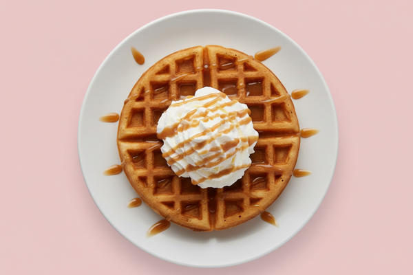 belgian waffle with whip cream & caramel on top with the background been #c85393